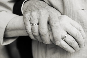 Elderly couple at golden wedding holding hands